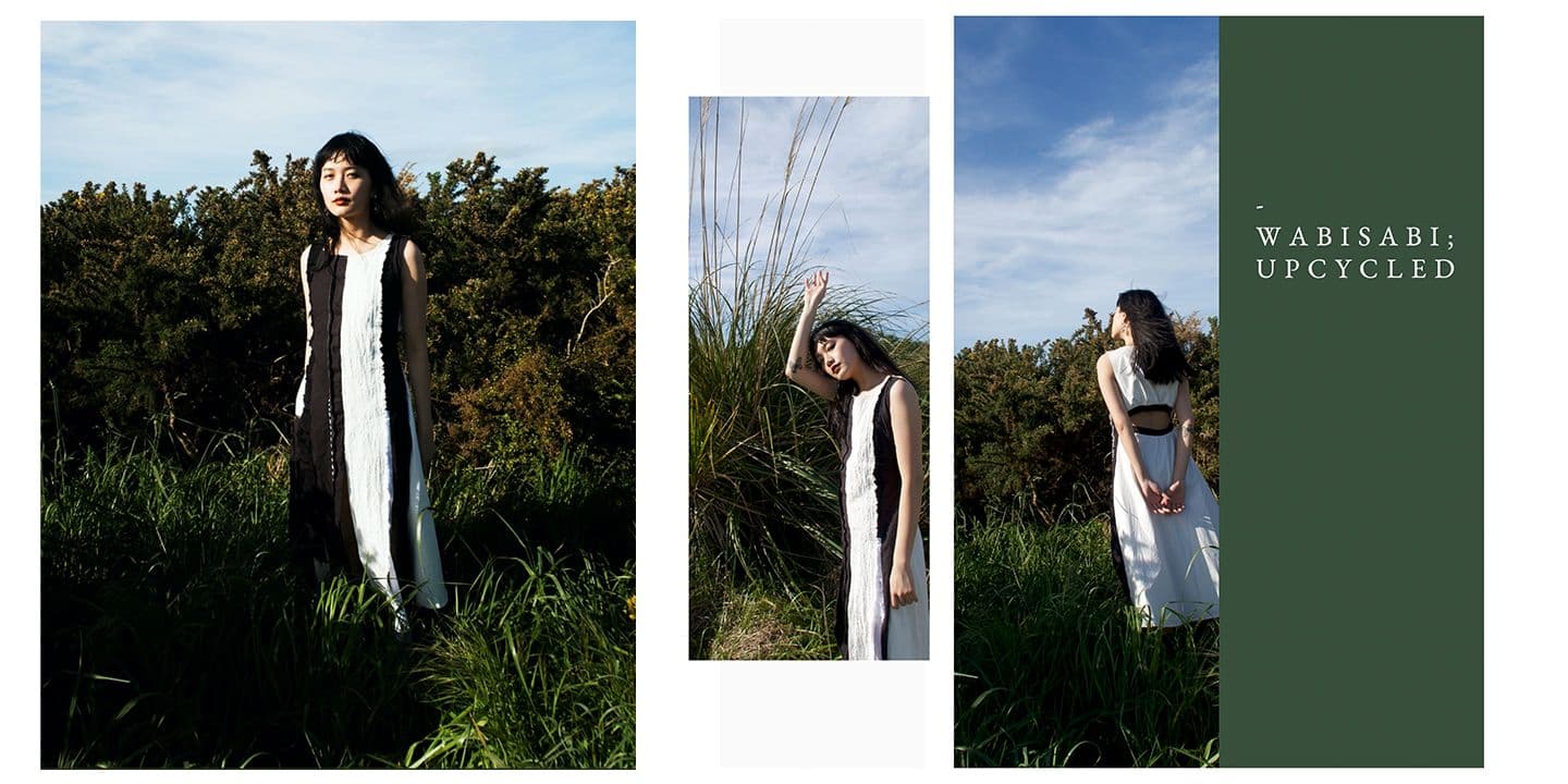 Model wearing a long black and white dress and standing in the nature